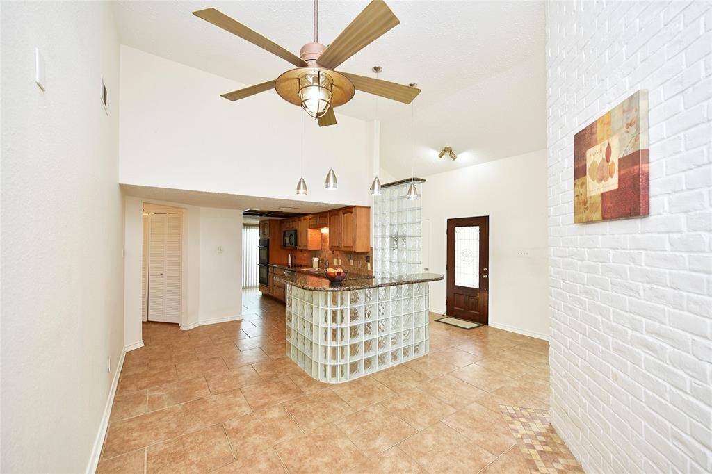 The tall glass wall adds privacy from the front door. Note the high ceilings seen here!