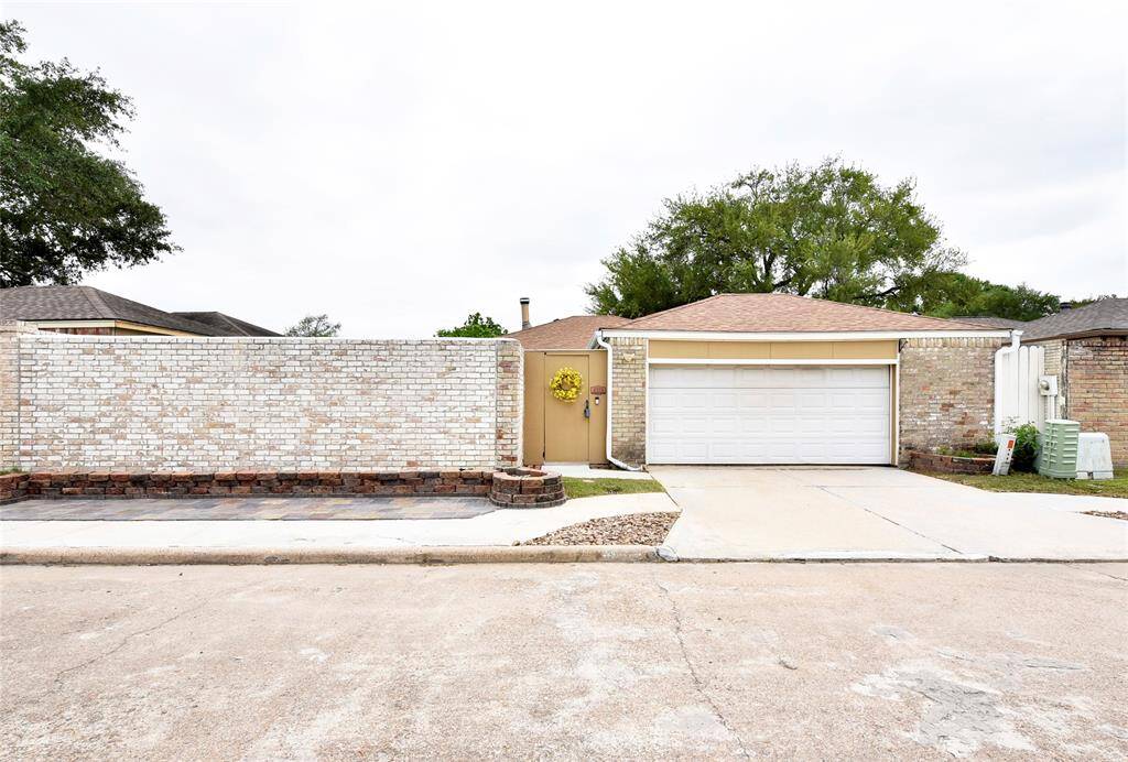 A low maintenance brick wall surrounds the property, and there are landscape beds up front if you'd like to indulge your green thumb. Double wide driveway allows for easy guest parking.