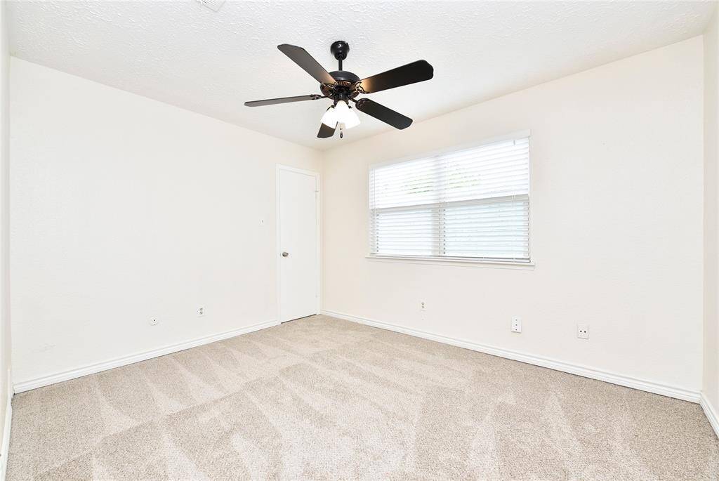 Another view of the second bedroom, with the double paned window looking out to the back yard.