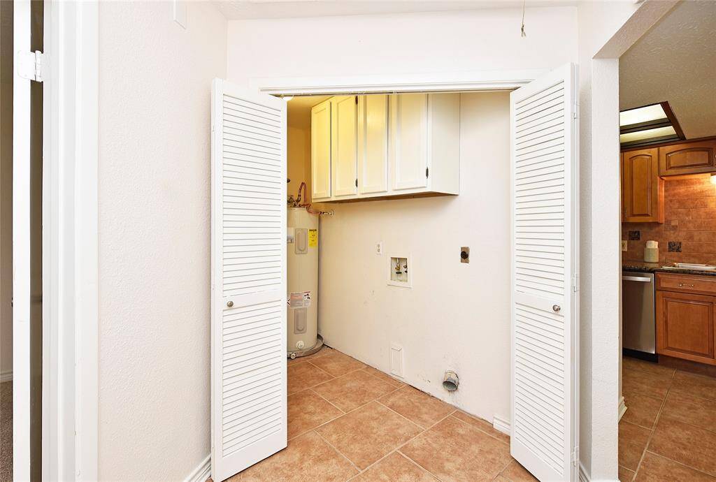 The utility room is bigger than you can see from this angle and has lots of cabinet storage over the washer and dryer.