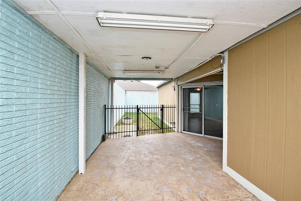 The covered patio on the side of the home has gates on both sides, and drainage.  Great spot for a morning cup of coffee or tea, or an evening glass of wine!