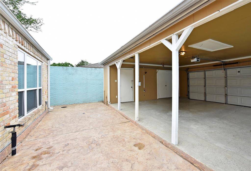 The carport is open on two sides, but functions just like a garage.  The stamped concrete patio has several drains to keep water away from the house.