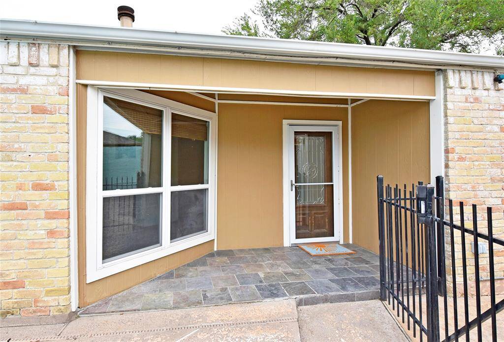 The front porch features slate tile and is covered to keep off the sun and rain. The original windows were all replaced with energy efficient double pane windows.