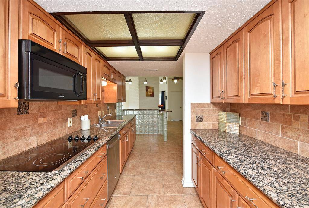 The kitchen was remodeled with beautiful, glazed maple cabinets and Baltic Brown granite counters.   Ceramic smooth top electric cook top keeps things looking sleek.