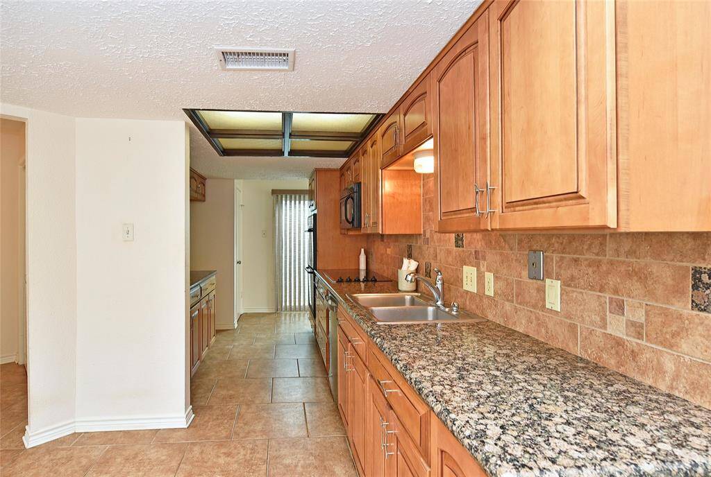 Plenty of counter space and the numerous cabinets feature adjustable shelves.  Lovely tile backsplash is easy to keep clean.