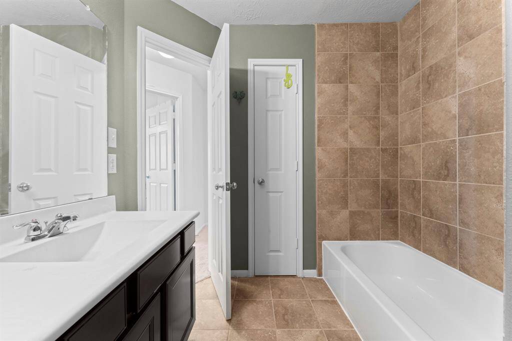The 2nd Full Bath also has a linen closet. Shower tiling to the ceiling.