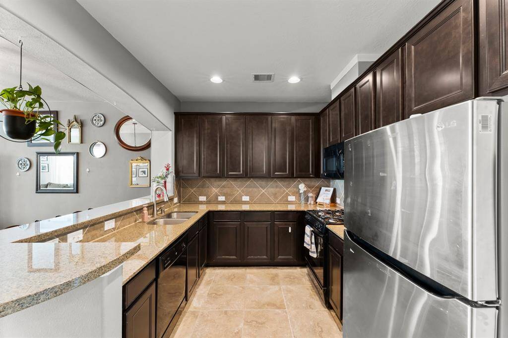 The Kitchen has granite counters, a gas range and oven, and plenty of cabinet storage space.