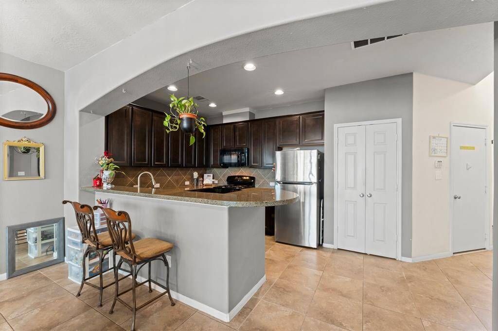 Bar stool seating on the kitchen countertop area. This photo was taken from the Breakfast Room looking back at Kitchen.
