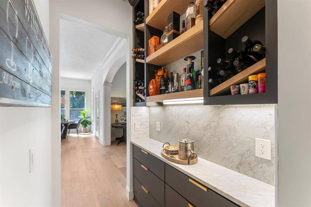 A custom dry bar is perfectly positioned between the dining room and kitchen, offering both style and convenience for entertaining.