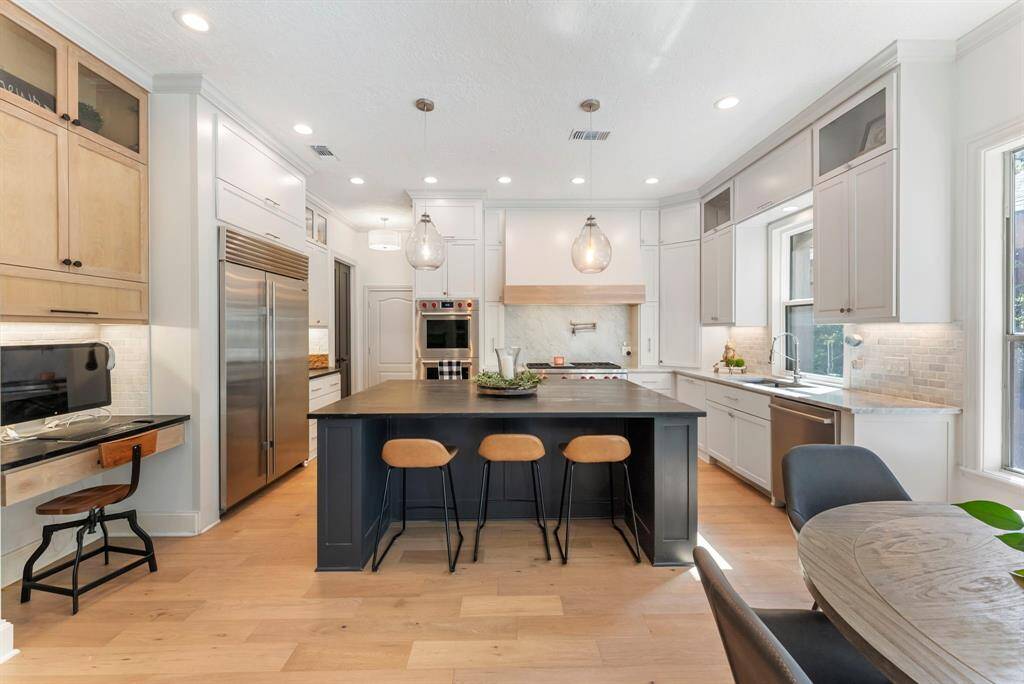 Standout features such as a built-in desk area, custom cabinetry, a convenient pot filler, and a built-in Sub-Zero fridge, this kitchen is designed for both style and functionality.
