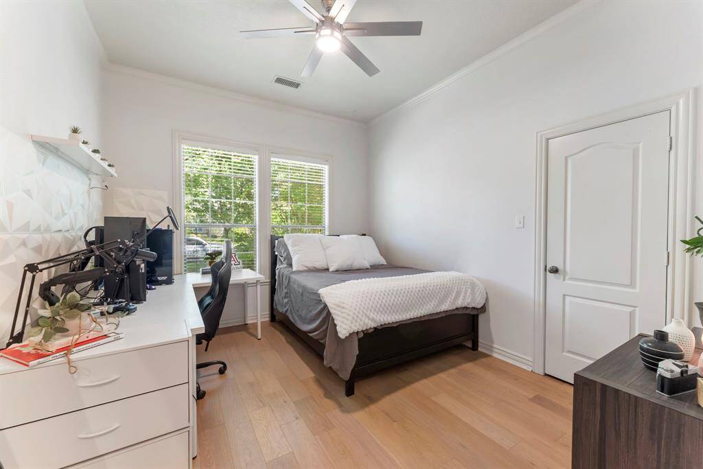This spacious and private guest bedroom features tall ceilings, ample windows, a generous closet, and its own en-suite bathroom—perfect for comfort and privacy.