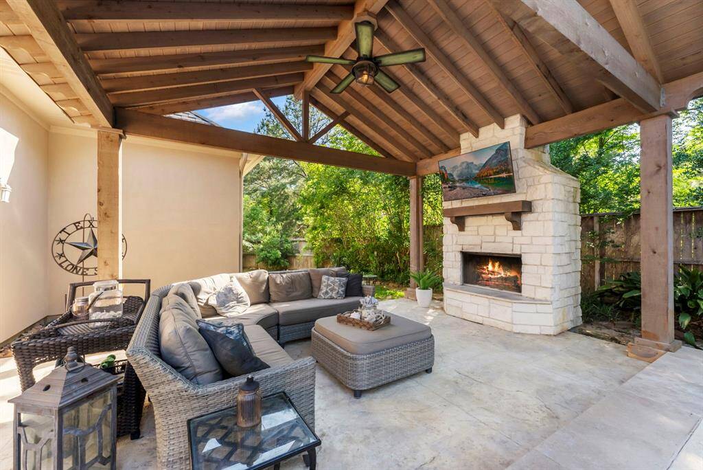 Outdoor living space with fireplace, total privacy and the perfect summer/winter living area next to the pool!