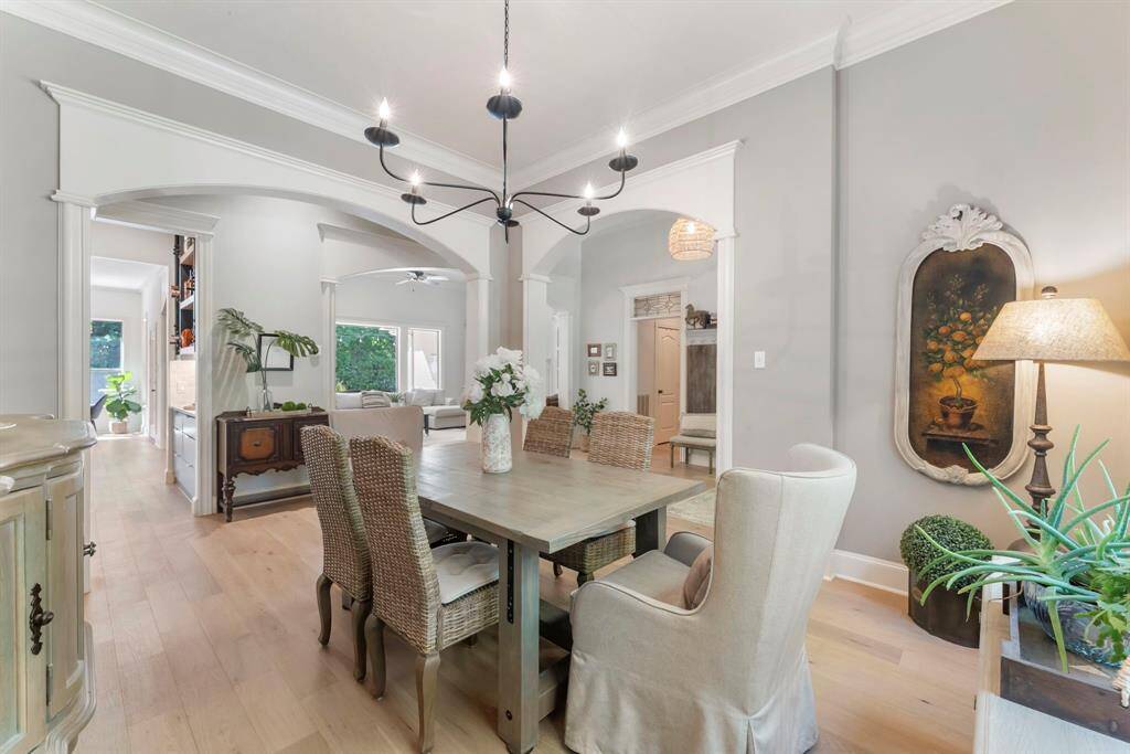 Custom millwork and soaring ceilings are showcased throughout, adding character and a sense of grandeur to every space.