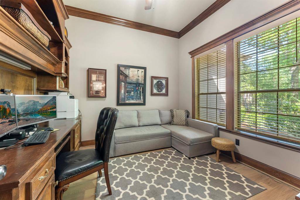 A private study at the front of the home features elegant French doors and a built-in workspace.