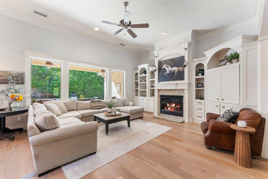 A built-in entertainment center anchors the space, complemented by a cozy gas log fireplace for warmth and ambiance.