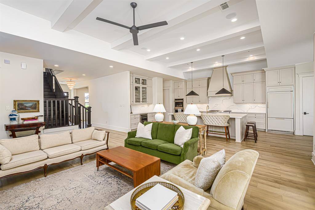 Open concept family room and kitchen with stunning beamed ceiling