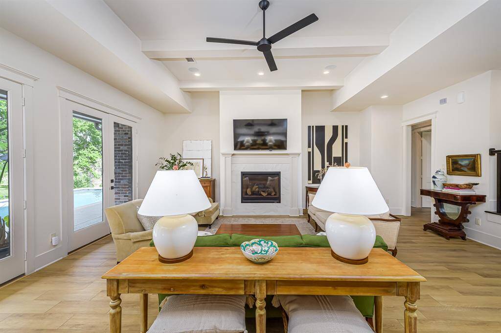 Beautiful fireplace in the family room overlooking the serene backyard and pool