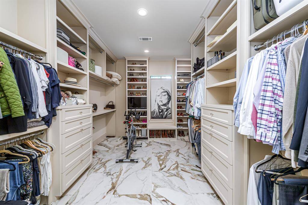 Primary closet complete wtih custom built ins. Additional laundry closet makes doing laundry much more convenient!