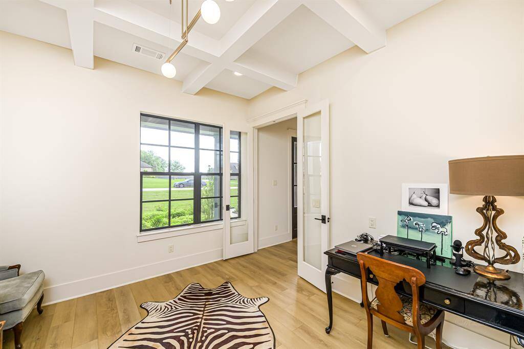 The coffered ceiling continues into the study/music room off the foyer