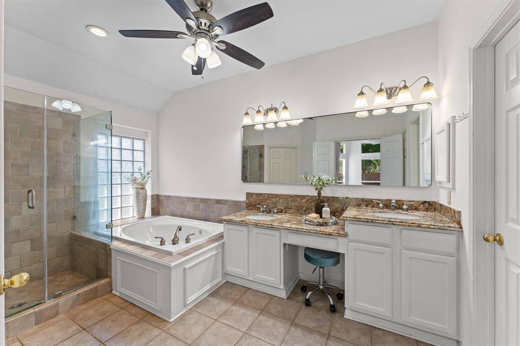 The en suite bathroom offers a spa-like retreat, designed for both relaxation and function. A double vanity provides ample space for morning routines, perfect for busy mornings or quiet evenings.
