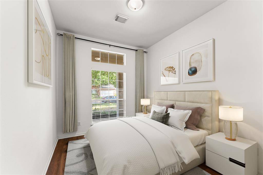 This second bedroom is filled with natural light, creating a cheerful and welcoming space.