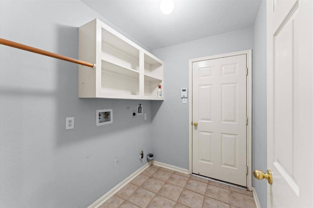 The laundry area is thoughtfully designed for ease and efficiency. With enough space for both washer and dryer, chores feel a little more manageable.