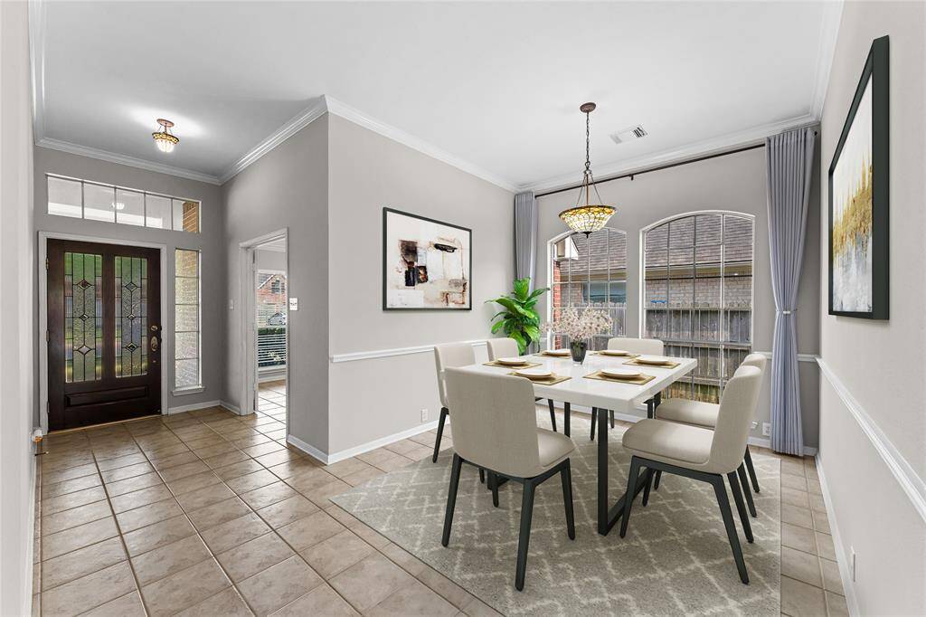 The dining area is bathed in natural light from the large windows, creating a warm and welcoming atmosphere for family meals.