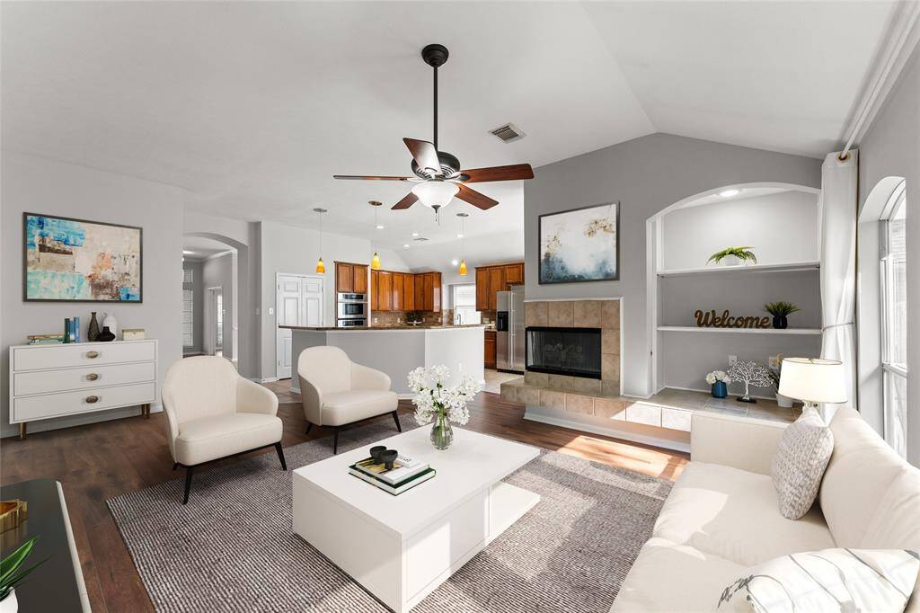 Wood flooring enhances the room’s warmth and sophistication.