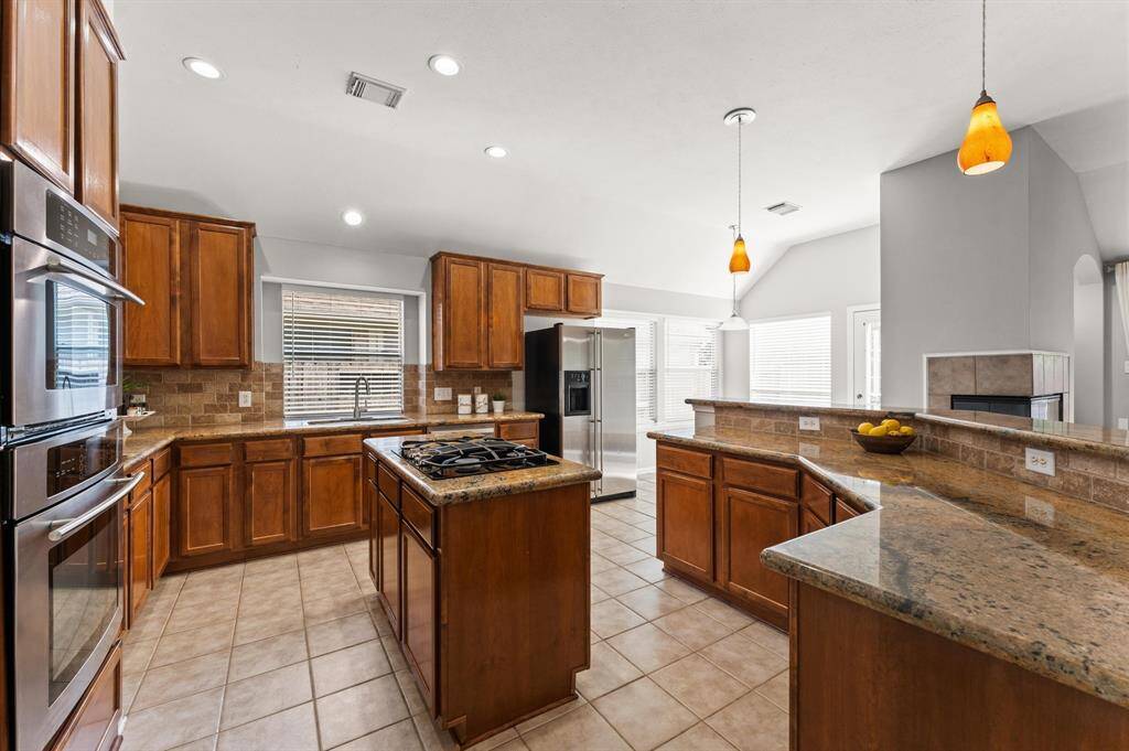 . Ample cabinetry offers plenty of storage for your kitchen essentials, while stainless steel appliances elevate both style and functionality.