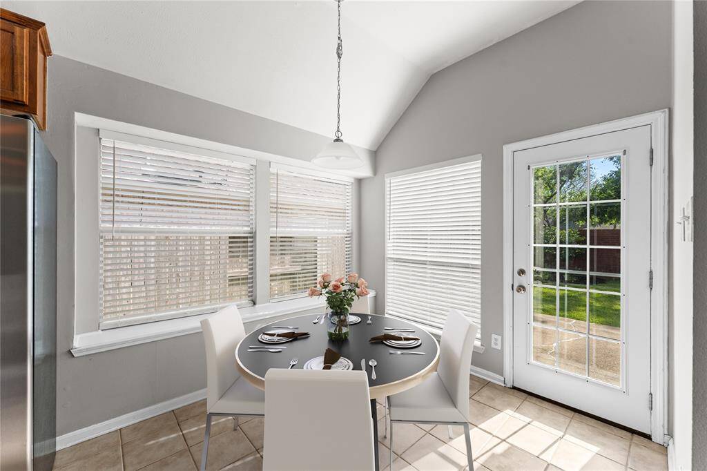 The breakfast area offers seamless access to the backyard, making it convenient for indoor-outdoor living.