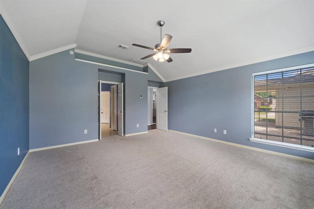 Opposite view of the Primary with doorways leading from the family room and into the bathroom.