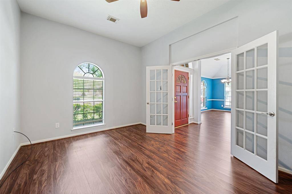 Opposite view in the office, showing the front entry and dining room.