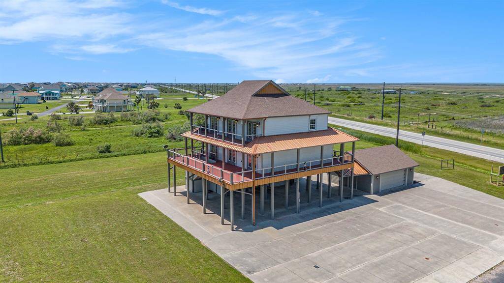 Imagine owning this substantial custom-built beach house, perfectly positioned on an expansive lot with two decks designed for soaking in the beautiful water views.