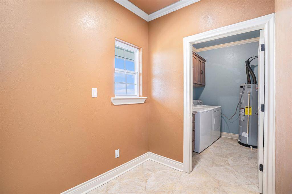 This versatile flex room can be utilized as a mudroom or for additional storage, and provides access to the laundry room.