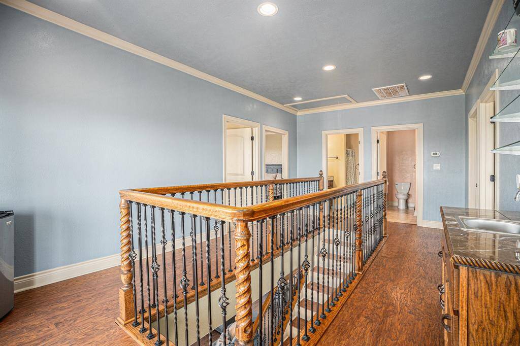 Upstairs, discover a conveniently situated wet bar, perfectly positioned by the French doors that open onto the second deck, making entertaining a breeze.