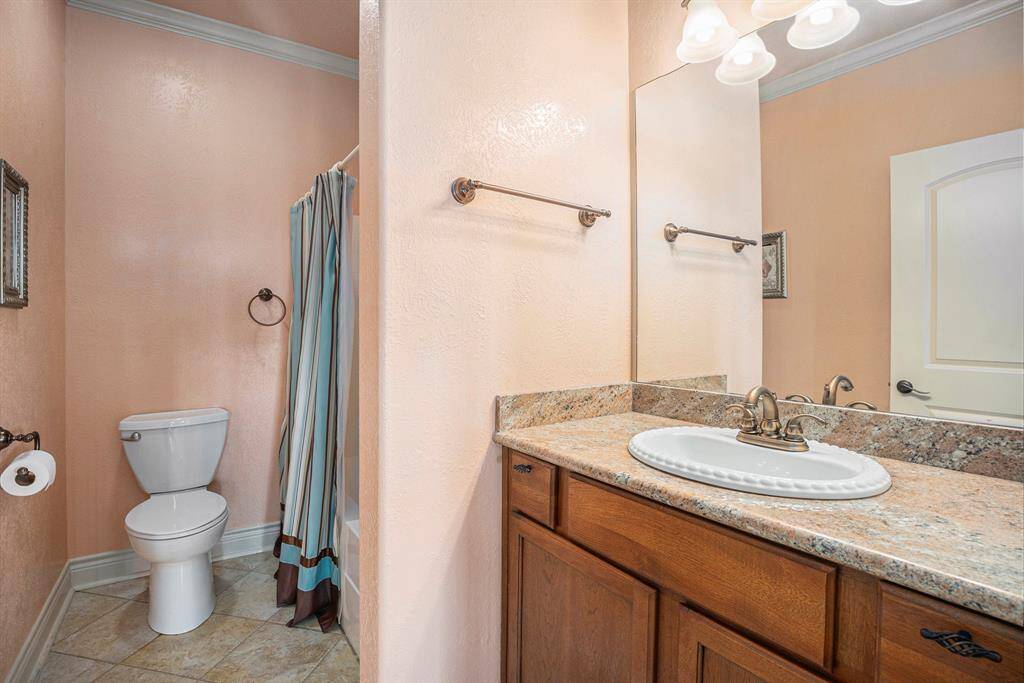 Another full bathroom, found at the top of the stairs, offers ideal functionality, serving as a convenient amenity for the adjacent secondary bedrooms.