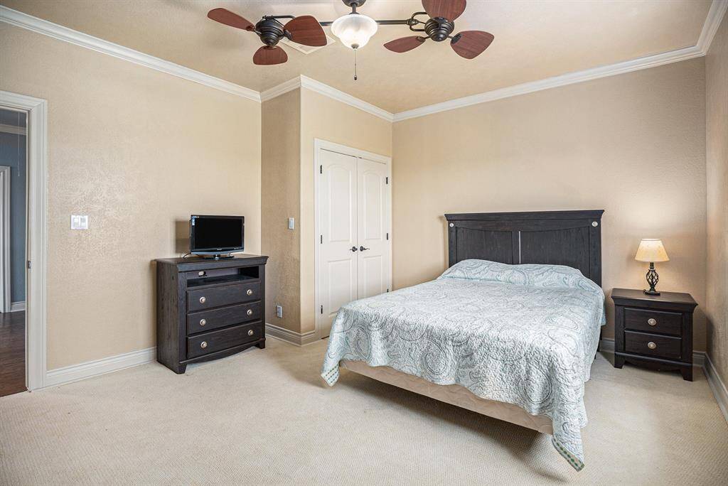 Nestled at the top of the stairs, this substantial secondary bedroom offers a comfortable retreat. Its generous size allows for flexible furnishing, while the addition of crown molding provides a touch of classic charm.