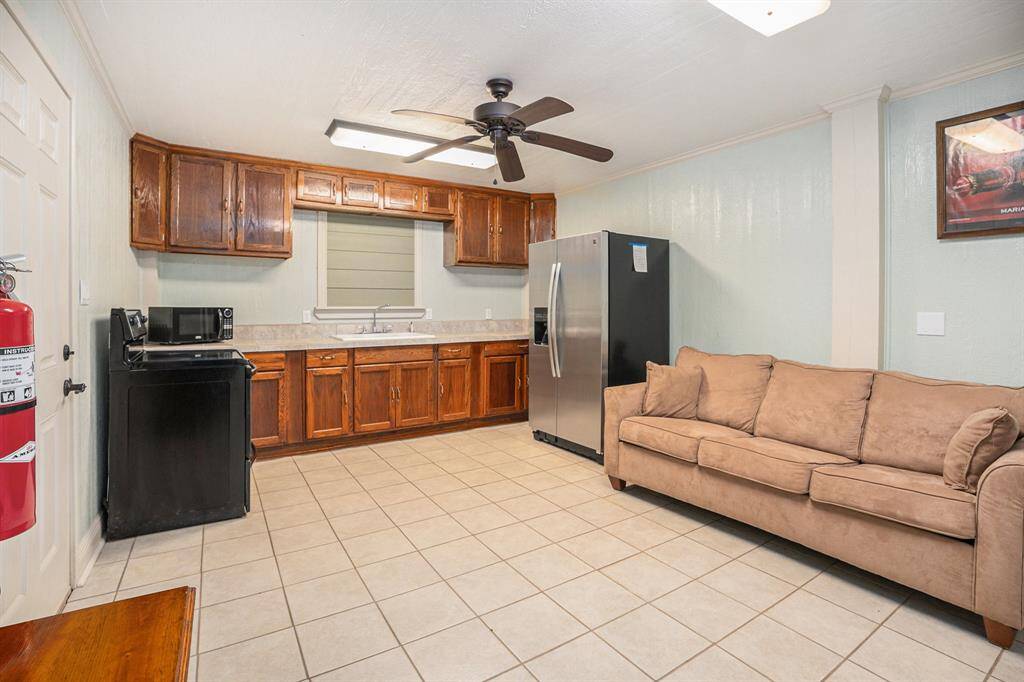 The first floor features a valuable secondary living space, boasting its own kitchen, a full bathroom, and a closet for added convenience.
