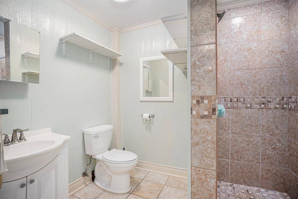 The full bathroom features a shower.