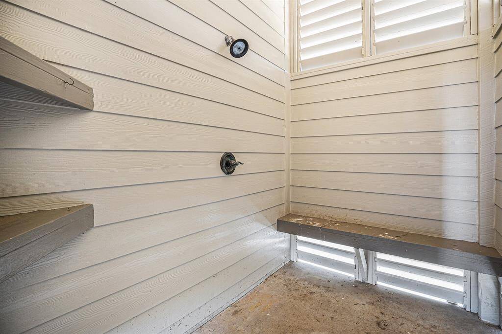 This enclosed outdoor shower offers a convenient and functional way to wash off sand or saltwater before heading inside.