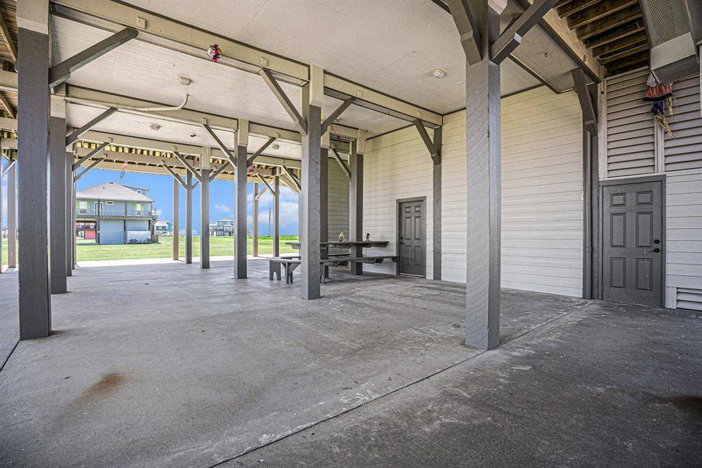 This covered outdoor area provides shelter from the elements and features a built-in picnic table, creating an ideal spot for outdoor meals and relaxation.