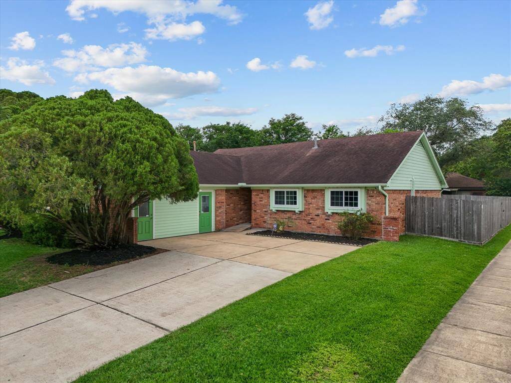 Charming single-story brick home on a spacious corner lot with mature trees and well-maintained landscaping. The property features a tidy lawn, a long driveway, and a fenced backyard, offering privacy and ample outdoor space. Ideal for buyers seeking a serene suburban setting.