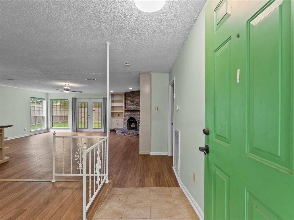 Entry opens to and open concept living area, with lots of natural light, fireplace and many built-ins