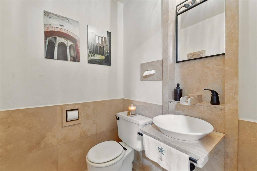 The current owners designed and crafted this one of a kind half bathroom sink with Cordova Shell Stone.