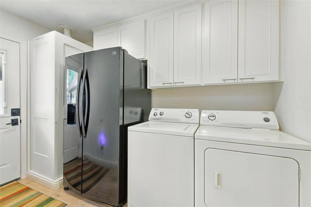 The laundry room accommodates a full size washer and dryer with room for a second refrigerator and lots of cabinet/storage space.