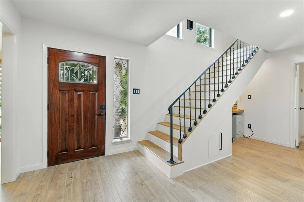 As soon as you walk through the front door you are greeted by vinyl plank floors that were installed in 2023.