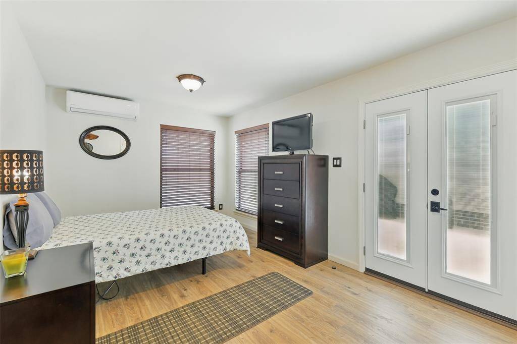 The mother in-law suite also has luxury vinyl plank floors (2023) and access to the back patio through the French door.
