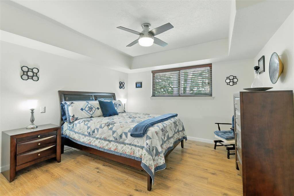 The third bedroom has vinyl plank floors (2016), tray ceilings, an updated ceiling fan and an en-suite bathroom.