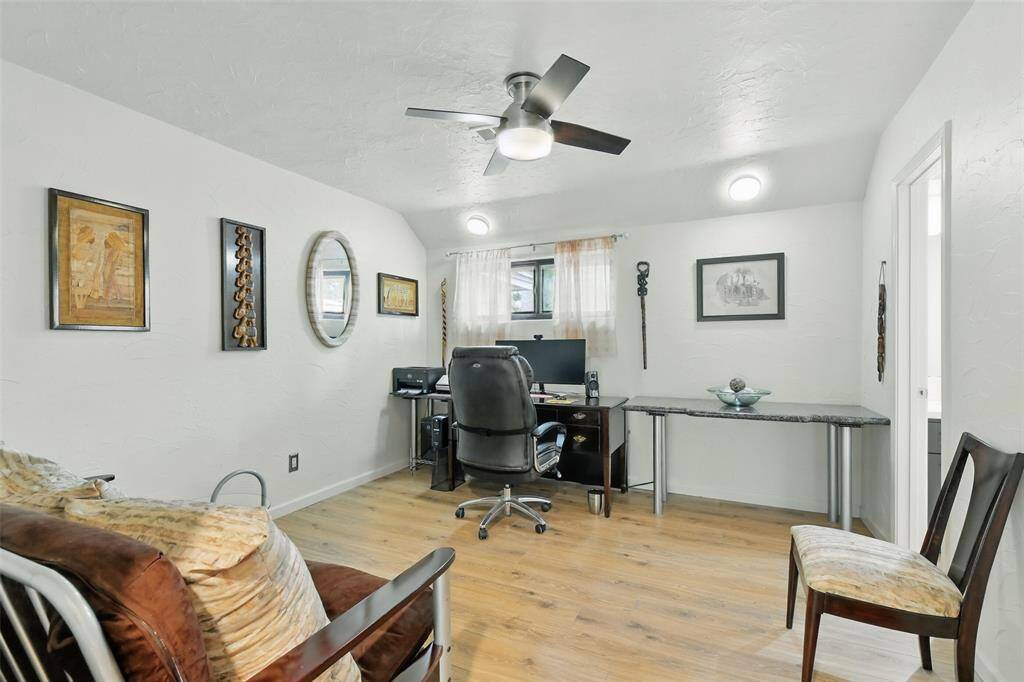 The fourth bedroom also features vinyl plank floors (2016) and an updated ceiling fan. The Jack N Jill full bathroom is shared between the fourth and fifth bedroom.