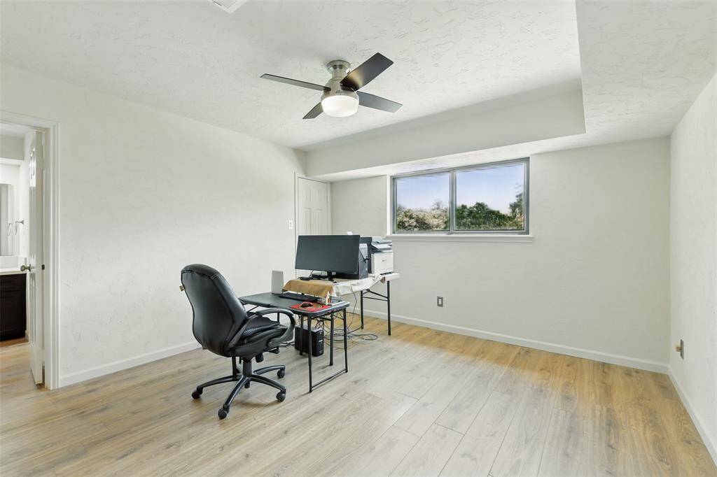 The fifth bedroom has vinyl plank floors (2016), walk-in closet, tray ceiling and an updated ceiling fan.